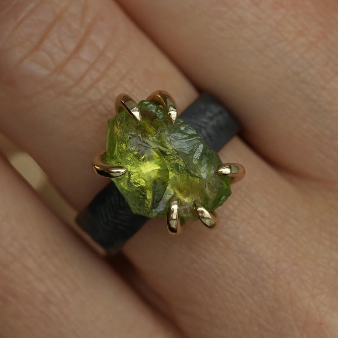 Raw Peridot Ring. Rustic Mixed Metal Gold and Black Silver Prong Set Raw Uncut Natural Peridot Statement Large Stone Feather Rebel Ring